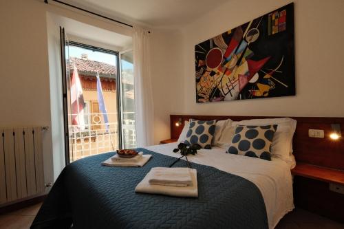 a bedroom with a bed with two towels on it at Locanda Milano 1873 in Brunate