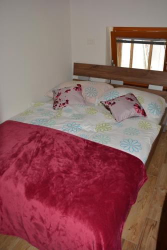 a bed with two pillows on it in a room at Apartmaji Kobal in Zoll