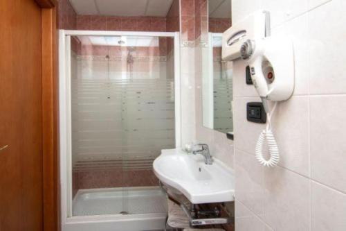 a small bathroom with a sink and a shower at Blu Hotel - Sure Hotel Collection by Best Western in Collegno