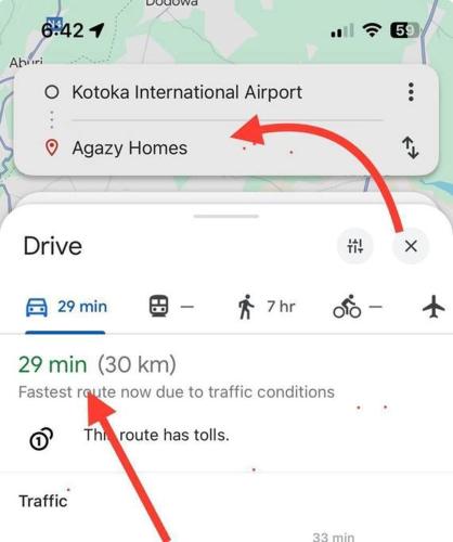 a screenshot of a cell phone with a red arrow at Harmony Villa in Tema