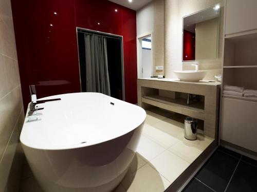 a bathroom with a white toilet and a sink at Grimm's Berlin Mitte in Berlin