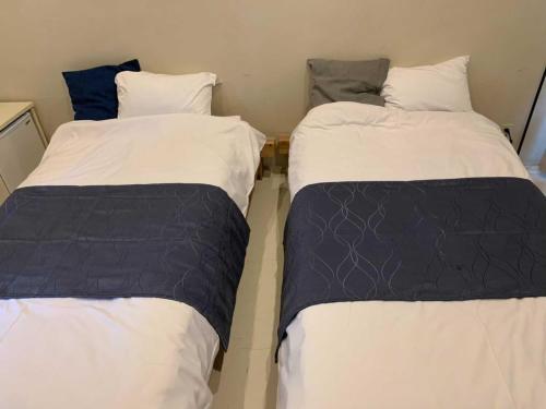 Cama ou camas em um quarto em Enfield一宮