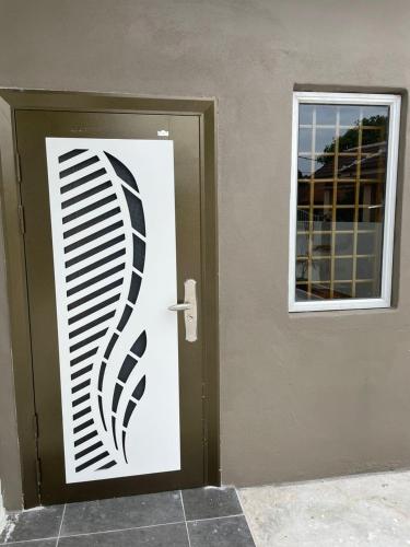 a door with a black and white decal on it at Sepang Putra Bagan Lalang Semi D House in Sungai Pelik