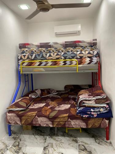 a room with two bunk beds in a room at Sepang Putra Bagan Lalang Semi D House in Sungai Pelik