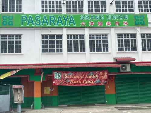 a building with a sign on the side of it at Sepang Putra Bagan Lalang Semi D House in Sungai Pelik
