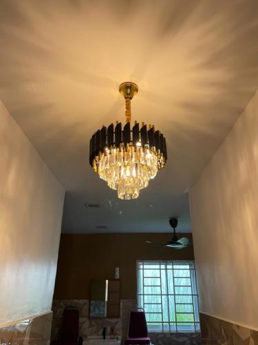 a chandelier hanging from a ceiling in a room at Sepang Putra Bagan Lalang Semi D House in Sungai Pelik