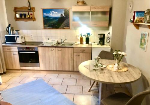 a kitchen with a table and a counter top at Sonnenhof Bad Schandau in Bad Schandau