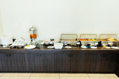 a buffet with a bunch of food on a table at Shivsagar Resort & Spa in Mahabaleshwar