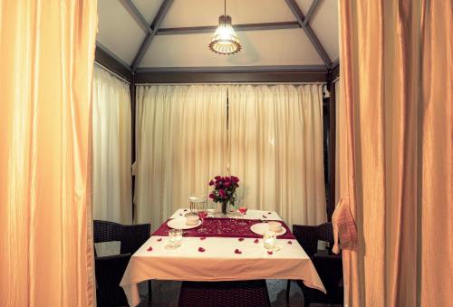 a table with a vase of flowers on it at Shivsagar Resort & Spa in Mahabaleshwar