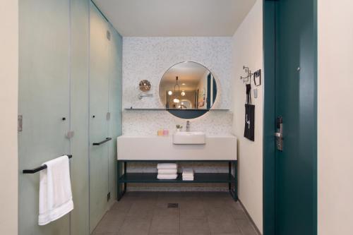 a bathroom with a sink and a mirror at lyf Cebu City managed by The Ascott Limited in Cebu City