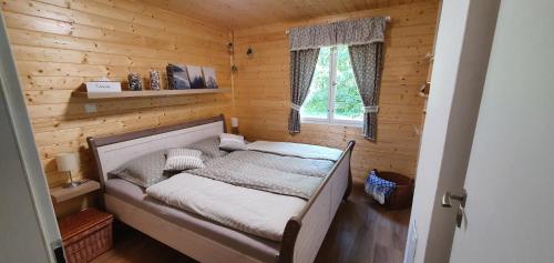 a bedroom with a bed in a wooden cabin at Geofond Chaty in Chotěboř