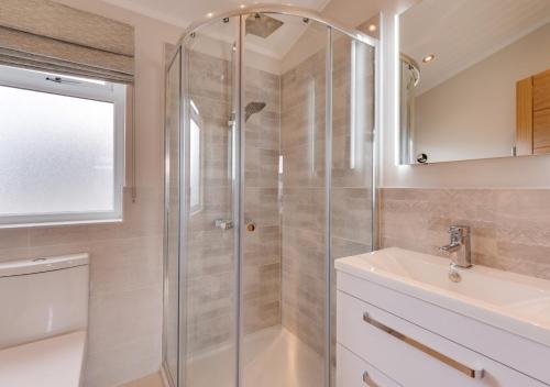 a bathroom with a shower and a sink at Briargate 38 in Burnham Market