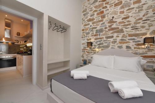 a bedroom with a large bed with towels on it at Alesio's house in Ermoupoli