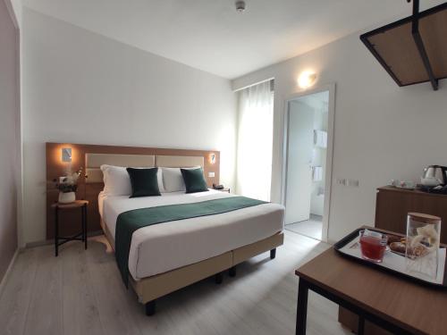 a bedroom with a large bed and a desk and a bed sidx sidx sidx sidx at Massimi City Garden in Rome