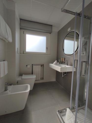 a bathroom with a sink and a toilet and a mirror at Massimi City Garden in Rome