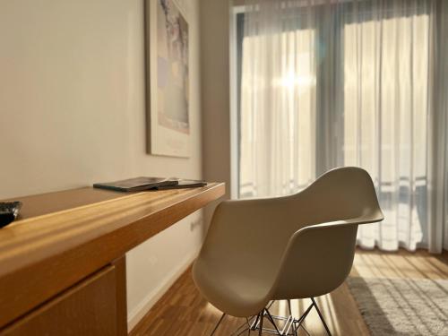 a desk with a chair in a room with a window at Grimm's Berlin Mitte in Berlin