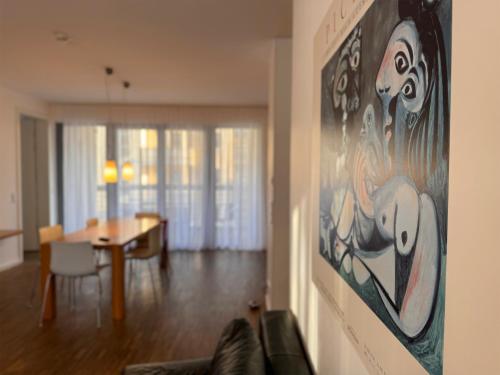 a living room with a painting on the wall at Grimm's Berlin Mitte in Berlin