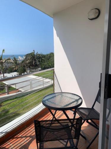 a table and two chairs on a balcony with a view at Chaka's Cove 74 in Ballito