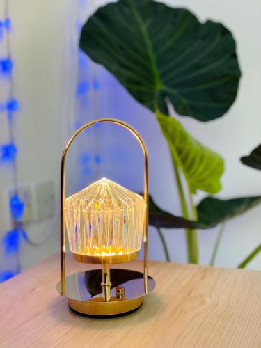 a lamp sitting on top of a wooden table at Stress-Free Cozy Private Room - heart of the city in Abu Dhabi
