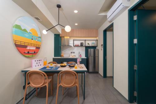 a kitchen with a table and chairs in a room at lyf Cebu City managed by The Ascott Limited in Cebu City