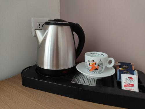 a coffee pot and a cup on a counter at Massimi City Garden in Rome