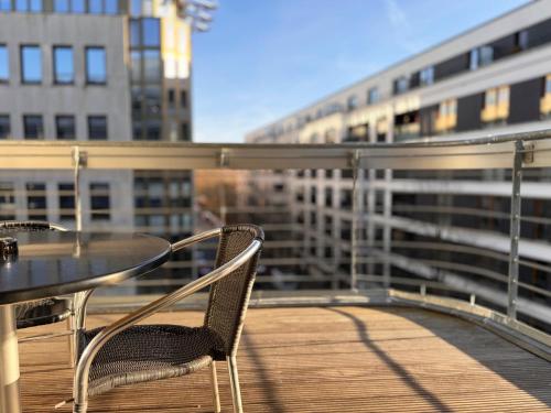a table and chairs on a balcony with a building at Grimm's Berlin Mitte in Berlin