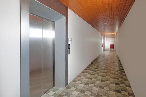 a hallway with a metal elevator in a building at The Bell Airport Phuket Hotel - SHA Extra Plus in Nai Yang Beach