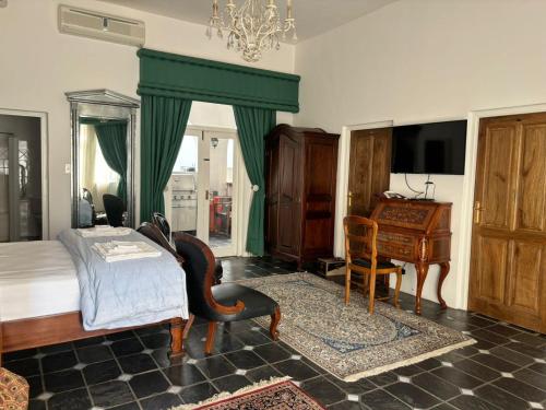 a bedroom with a bed and a table and a piano at Waterkloof Mansion Boutique Hotel in Pretoria