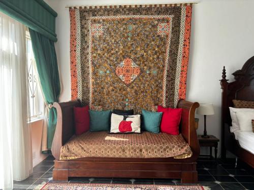a couch with pillows on it in a room at Waterkloof Mansion Boutique Hotel in Pretoria