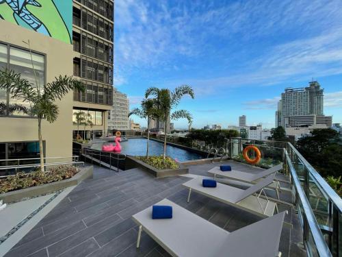 a rooftop patio with a pool on a building at lyf Cebu City managed by The Ascott Limited in Cebu City