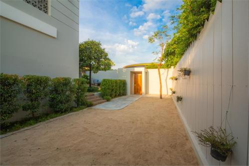 an alleyway leading to a house with a door at Castle Bayview Resort & Spa in Kampot