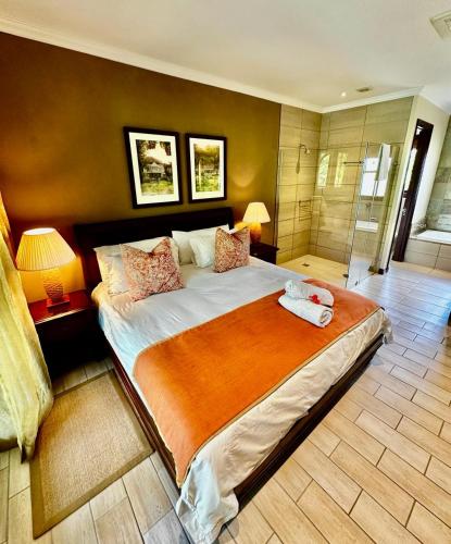 a bedroom with a large bed and a shower at Eden Island Luxury Accommodation in Eden Island