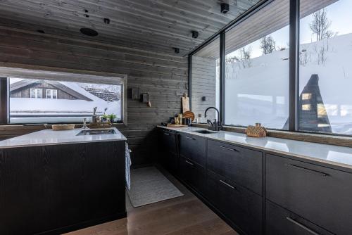 a kitchen with a sink and a large window at Tindekroken 5, Hemsedal in Fausko