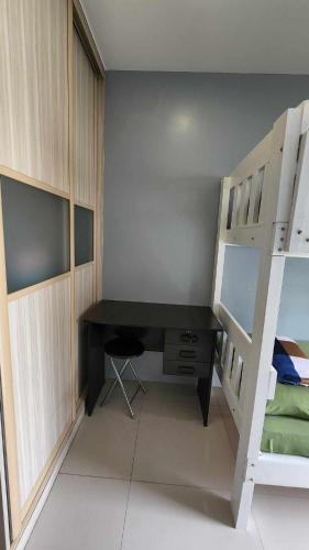a bedroom with a desk and a bunk bed at Conifer Baguio in Baguio