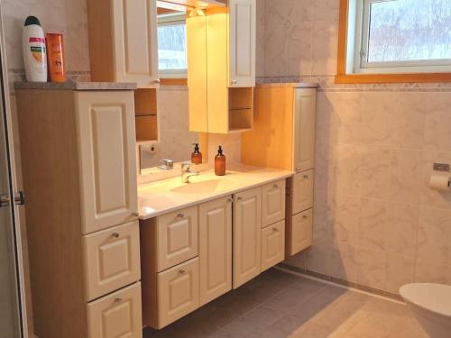 a white bathroom with a sink and a toilet at Blabergan Lodge in Nord-Lenangen