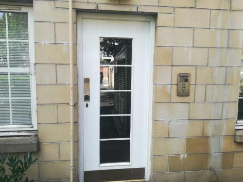 a white door on the side of a building at Attractive Edinburgh Leith Apartment in Edinburgh