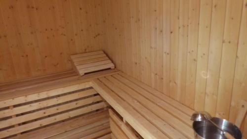 a corner of a wooden sauna with wooden panels at Gut-Rattelvitz-Parterre-C-hochwertig-Sauna-Kamin-eTankstelle-Spielscheune-15-000qm-Parkland in Gingst