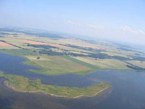 an aerial view of a large body of water at Gut-Rattelvitz-Parterre-C-hochwertig-Sauna-Kamin-eTankstelle-Spielscheune-15-000qm-Parkland in Gingst