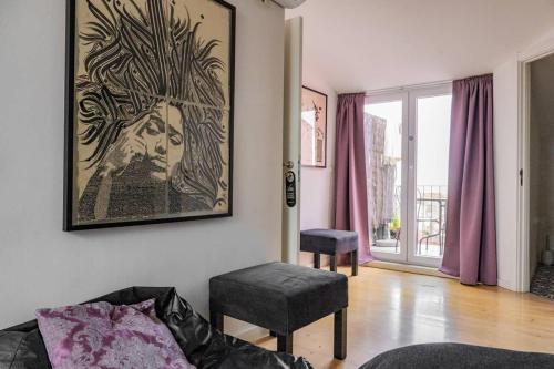 a living room with a couch and a picture on the wall at Tings Lisbon in Lisbon