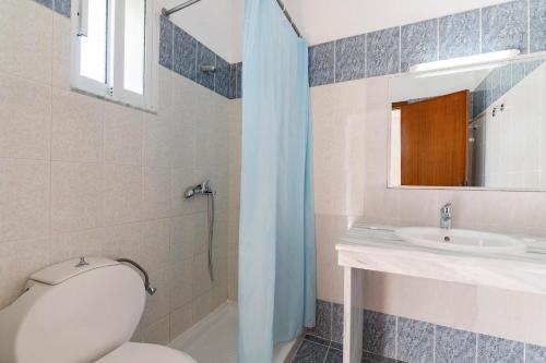 a bathroom with a toilet and a sink at Summer View in Theologos