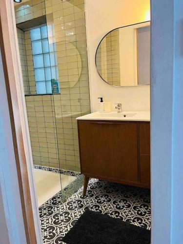 a bathroom with a shower and a sink and a mirror at Le Capucin - Au coeur de Marseille in Marseille