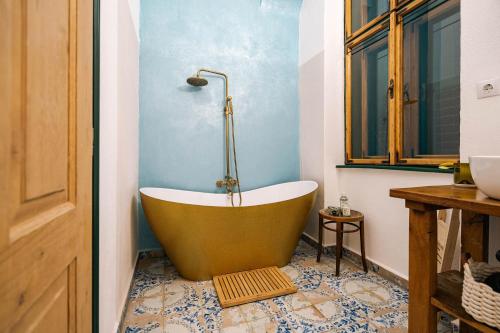 a bath tub sitting on a floor in a bathroom at Ani GuestHouse Richis in Richişu