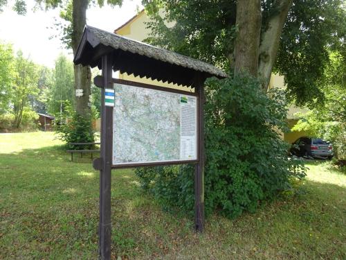 a sign in the grass in a park at Ubytování Hamry in Hlinsko