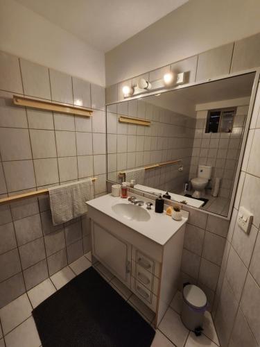 a bathroom with a sink and a mirror at Self Contained Guesthouse for 6+ w/Pool in Gold Coast