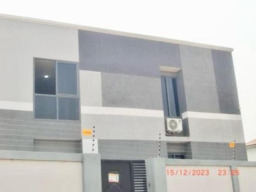 a large building with a speaker on the side of it at Spacious Holiday Let Wi-Fi & Private Amenities Oyibi in Oyibi