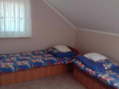 1 dormitorio con 2 camas y ventana en Domek Rowy, en Rowy