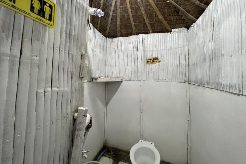 a dirty bathroom with a toilet and a sink at Lover's Point Beach Front Resort in Lian