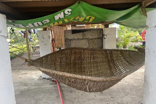 a hammock with a green covering on top of it at Lover's Point Beach Front Resort in Lian