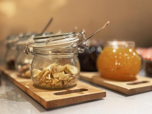 a jar of mushrooms on a wooden cutting board at Grimm's Berlin Mitte in Berlin
