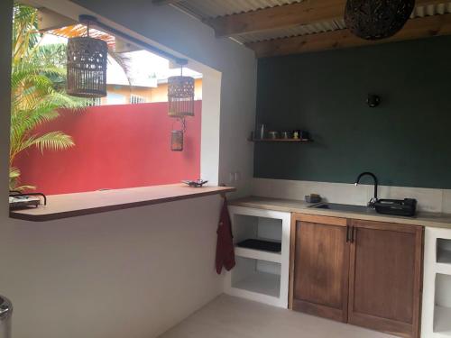 a kitchen with a counter and a window and a sink at Tiny house Les Cactus - Bungalow St Gilles les hauts in Saint-Paul